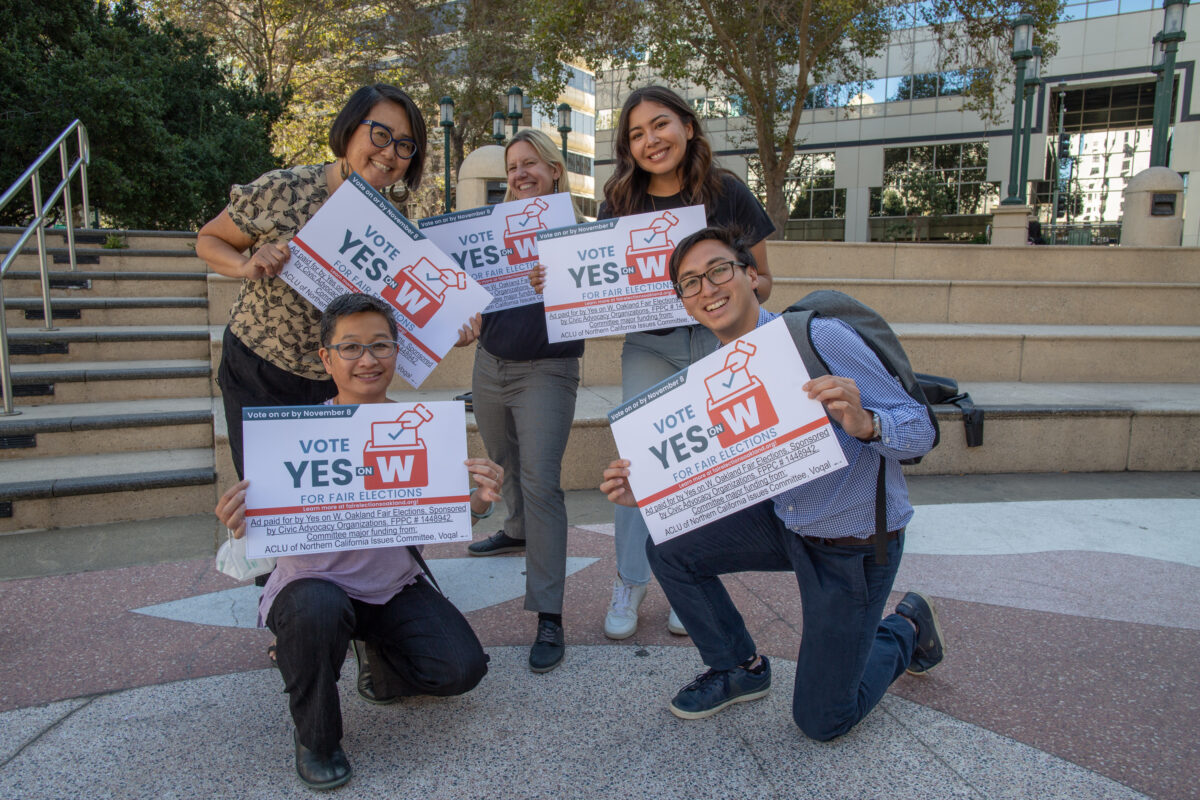 ALC Voting Rights Staff and community partners pose in a group photo holding signs that read "Yes on Measure W"